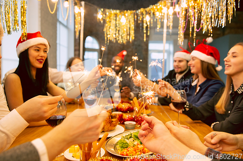 Image of Happy co-workers celebrating while company party for New Year and Christmas