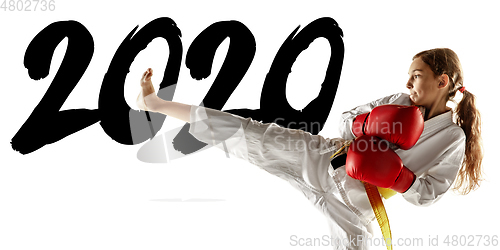 Image of Confident junior in kimono practicing hand-to-hand combat, martial arts