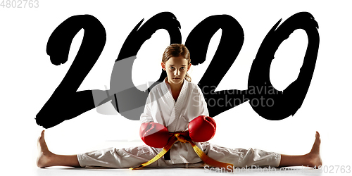 Image of Confident junior in kimono practicing hand-to-hand combat, martial arts