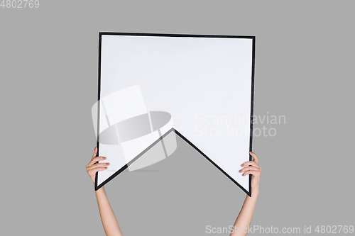 Image of Hands holding the sign of bookmark on grey studio background