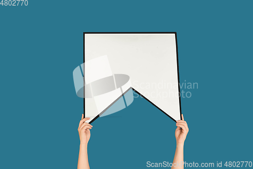 Image of Hands holding the sign of bookmark on blue studio background