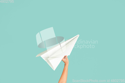 Image of Hands holding the sign of paper airplane on studio background