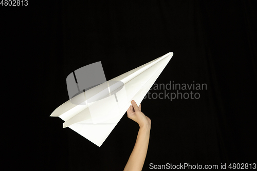 Image of Hands holding the sign of paper airplane on studio background