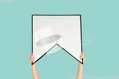 Image of Hands holding the sign of bookmark on blue studio background