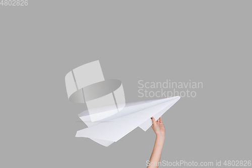 Image of Hands holding the sign of paper airplane on studio background