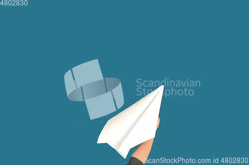 Image of Hands holding the sign of paper airplane on studio background