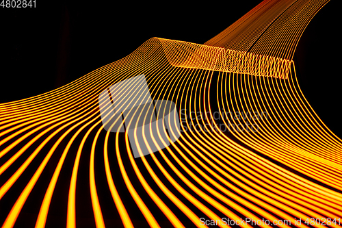 Image of Bright neon line designed background, shot with long exposure, yellow gold