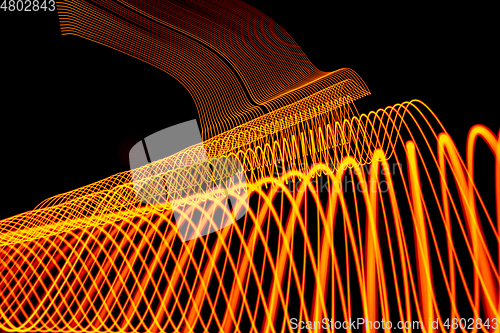 Image of Bright neon line designed background, shot with long exposure, yellow gold
