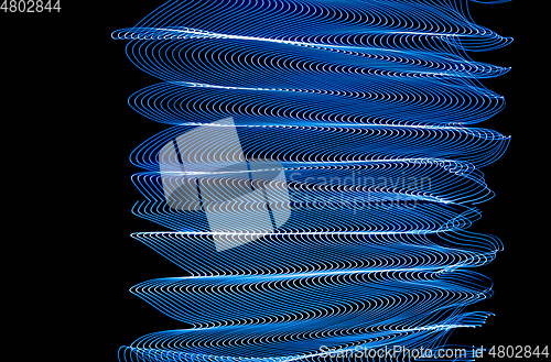 Image of Bright neon line designed background, shot with long exposure, blue