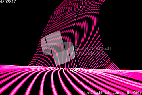 Image of Bright neon line designed background, shot with long exposure, pink