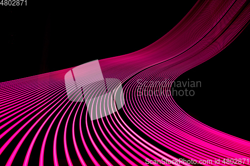 Image of Bright neon line designed background, shot with long exposure, pink