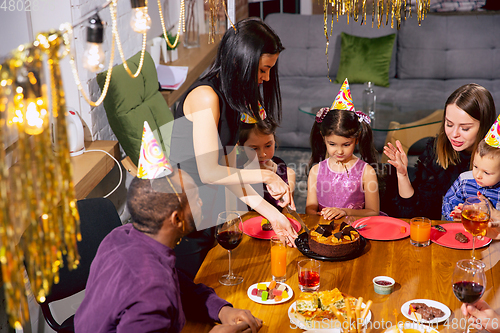 Image of Portrait of happy family celebrating a birthday at home