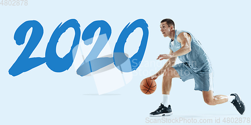 Image of Young caucasian basketball player against white studio background