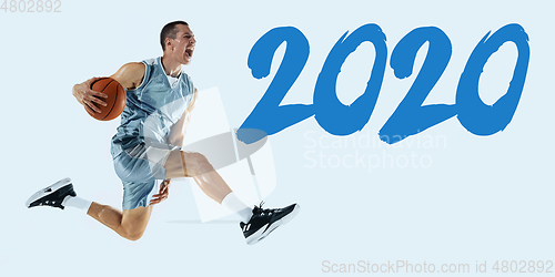 Image of Young caucasian basketball player against white studio background