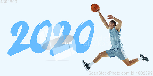 Image of Young caucasian basketball player against white studio background