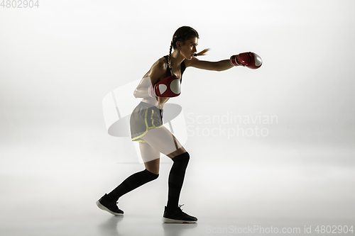 Image of Fit caucasian woman in sportswear boxing isolated on white studio background