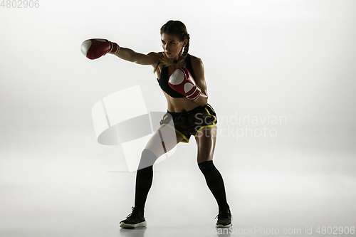 Image of Fit caucasian woman in sportswear boxing isolated on white studio background
