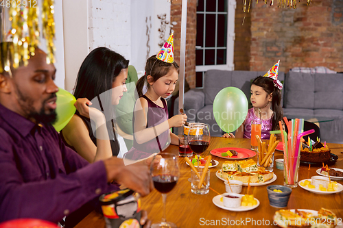 Image of Portrait of happy family celebrating a birthday at home