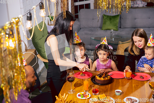 Image of Portrait of happy family celebrating a birthday at home