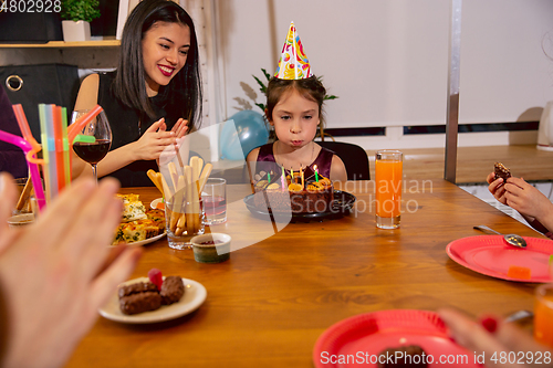 Image of Portrait of happy family celebrating a birthday at home