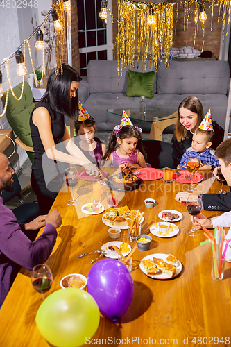 Image of Portrait of happy family celebrating a birthday at home