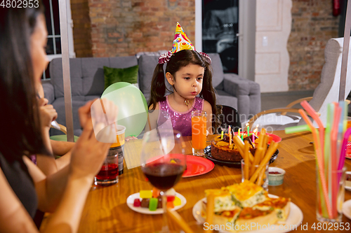 Image of Mother and daughter celebrating a birthday at home