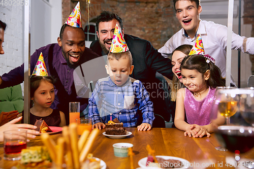 Image of Portrait of happy family celebrating a birthday at home