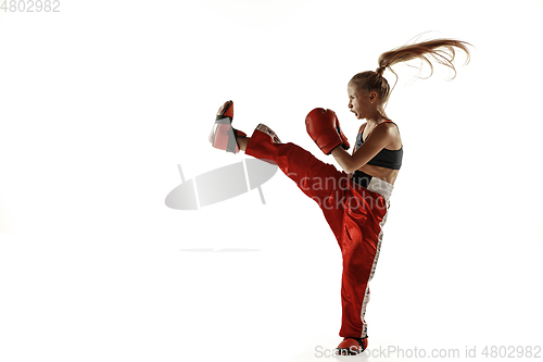 Image of Young female kickboxing fighter training isolated on white background