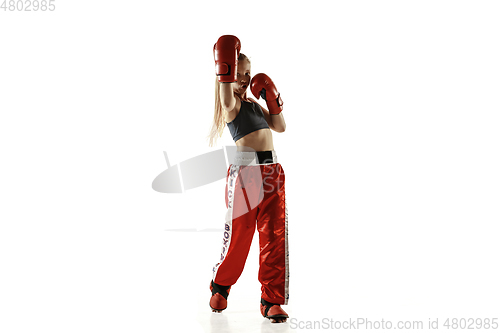 Image of Young female kickboxing fighter training isolated on white background