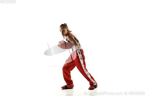 Image of Young female kickboxing fighter training isolated on white background