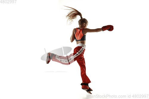 Image of Young female kickboxing fighter training isolated on white background