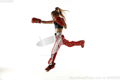 Image of Young female kickboxing fighter training isolated on white background