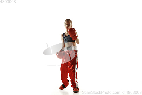 Image of Young female kickboxing fighter training isolated on white background