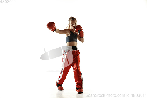 Image of Young female kickboxing fighter training isolated on white background