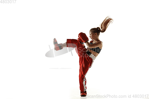 Image of Young female kickboxing fighter training isolated on white background