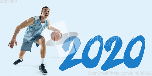 Image of Young caucasian basketball player against white studio background