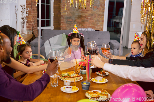 Image of Portrait of happy family celebrating a birthday at home