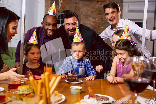 Image of Portrait of happy family celebrating a birthday at home