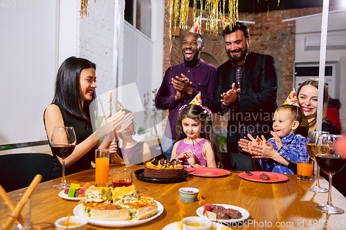 Image of Portrait of happy family celebrating a birthday at home