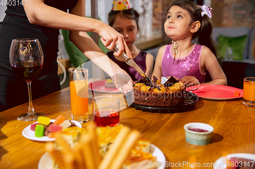 Image of Portrait of happy family celebrating a birthday at home