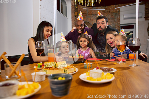 Image of Portrait of happy family celebrating a birthday at home