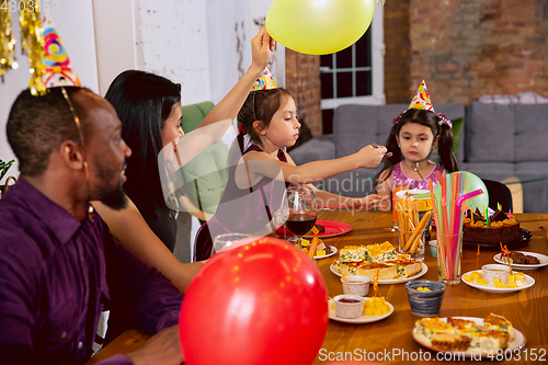 Image of Portrait of happy family celebrating a birthday at home