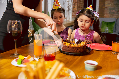 Image of Portrait of happy family celebrating a birthday at home