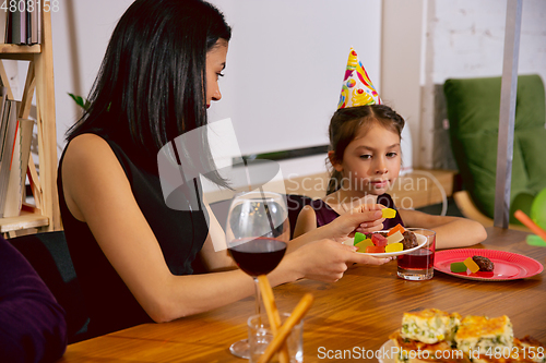 Image of Mother and daughter celebrating a birthday at home