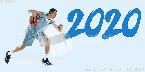 Image of Young caucasian basketball player against white studio background