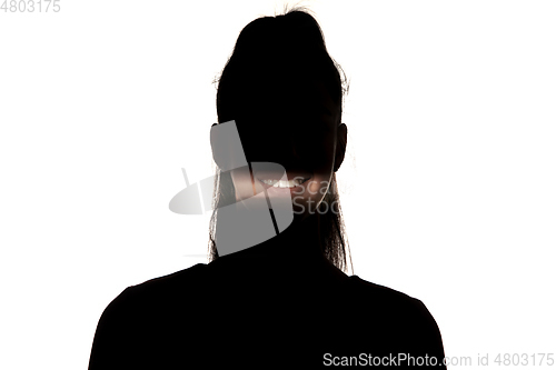 Image of Dramatic portrait of a girl in the dark on white studio background.