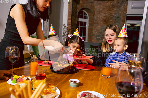 Image of Portrait of happy family celebrating a birthday at home