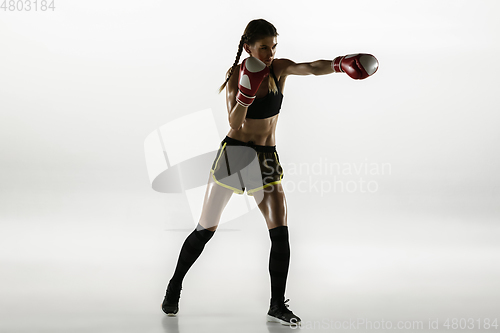 Image of Fit caucasian woman in sportswear boxing isolated on white studio background