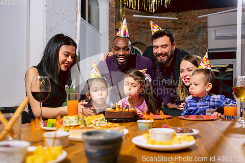 Image of Portrait of happy family celebrating a birthday at home