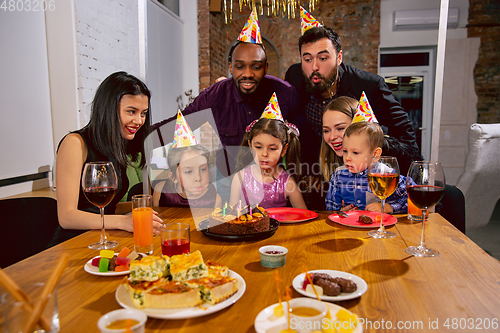 Image of Portrait of happy family celebrating a birthday at home